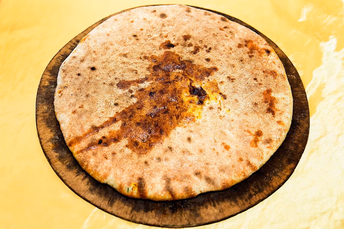 Why is khobza medfouna called 'Berber pizza'?