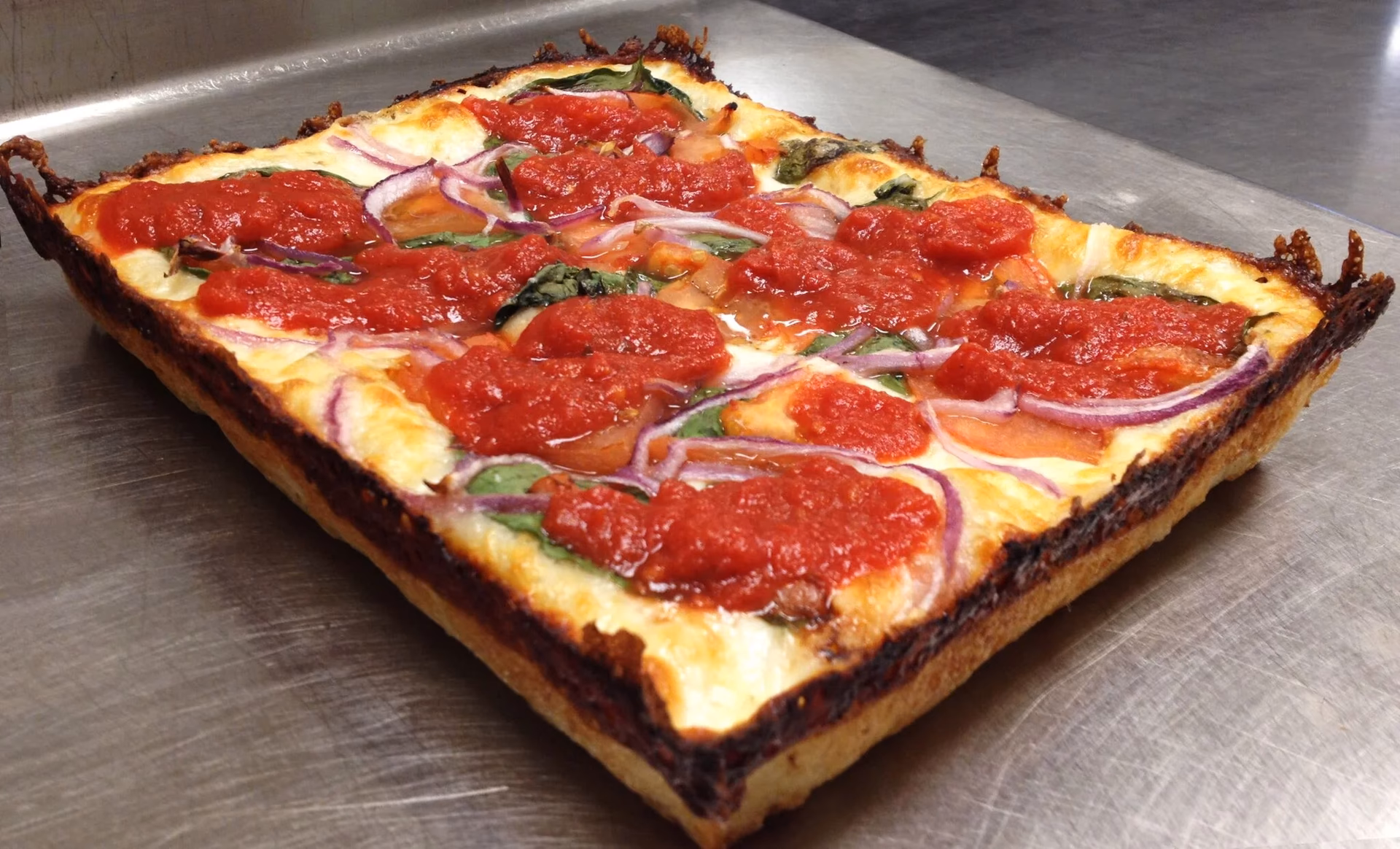 Who invented Detroit-style pizza?