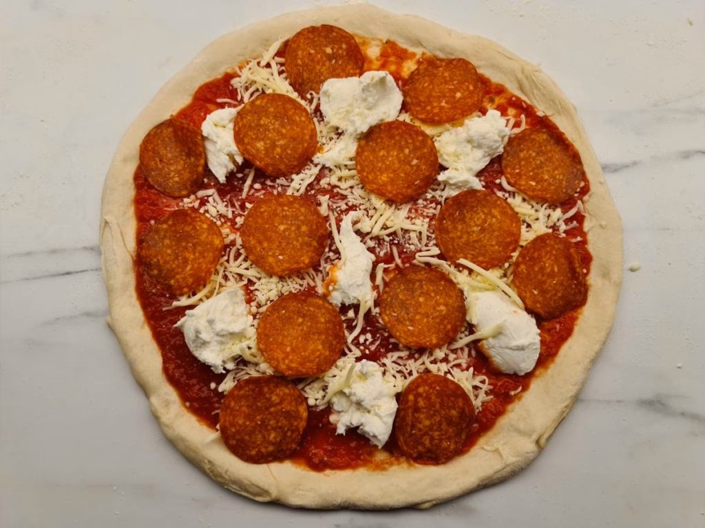 Should you put pizza toppings above cheese?