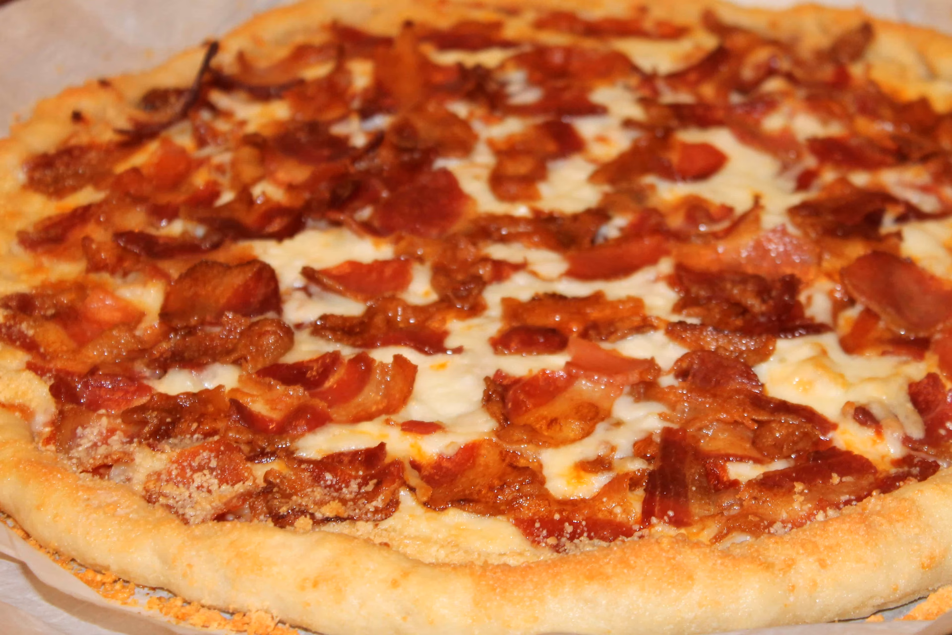 Can you put bacon grease on pizza?