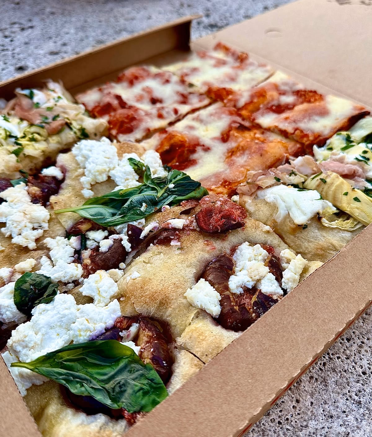 Where did pizza al taglio come from?