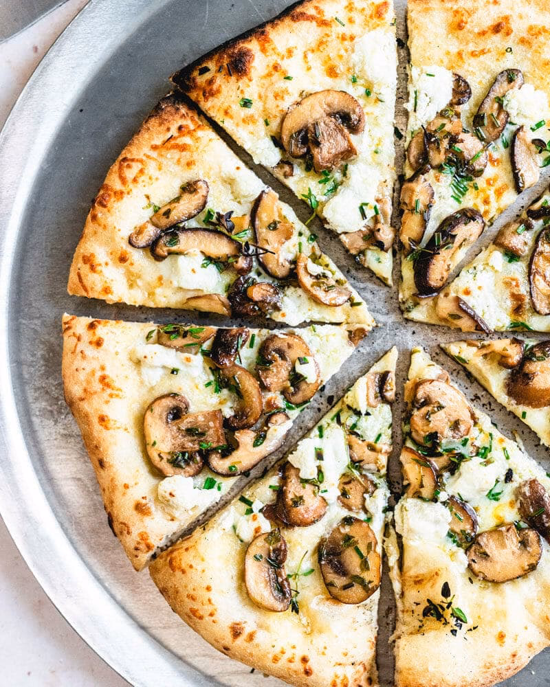 How to top the pizza with wild mushroom mix?